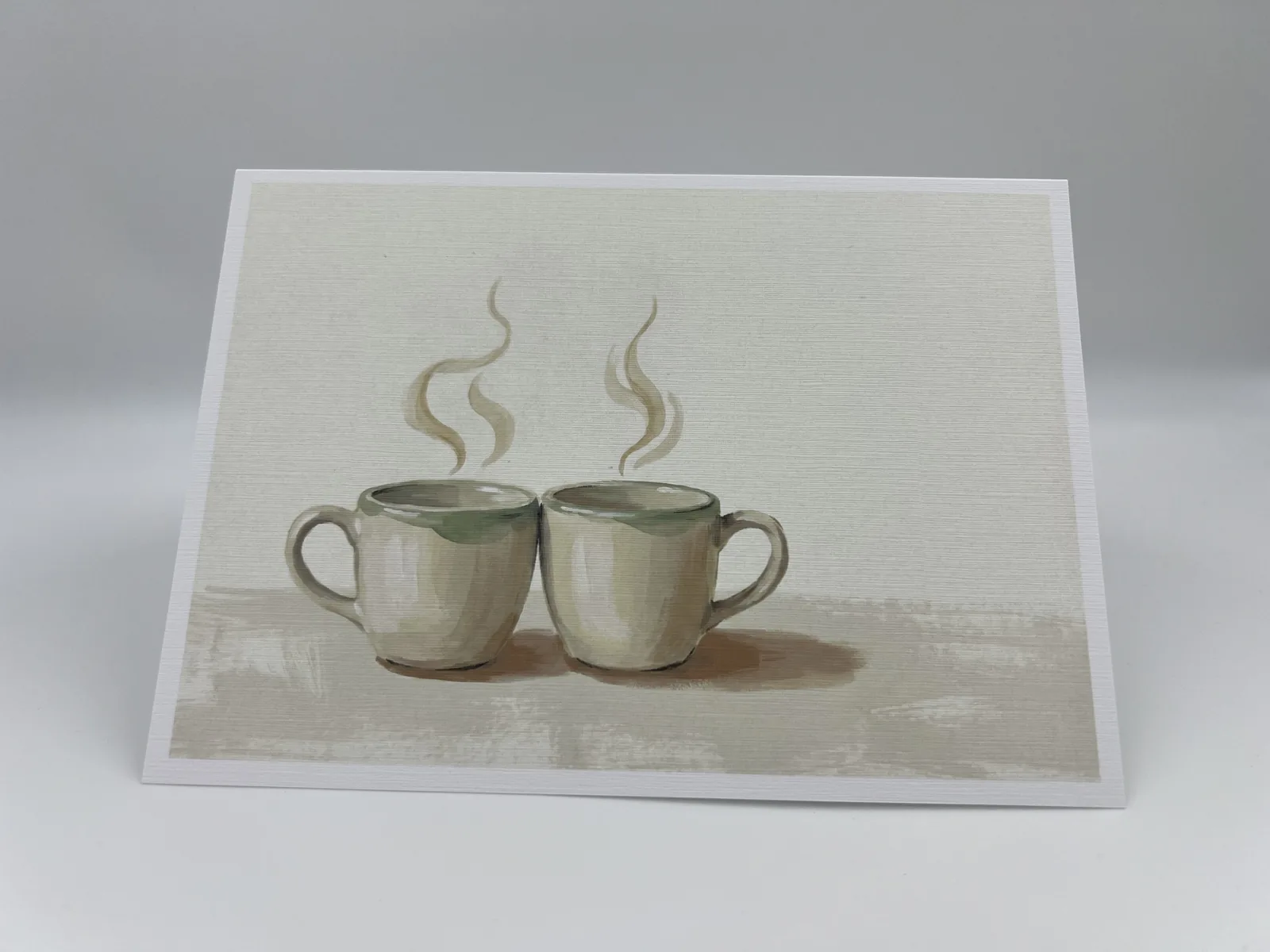 A wedding thank-you card showing two steaming mugs nestled side by side